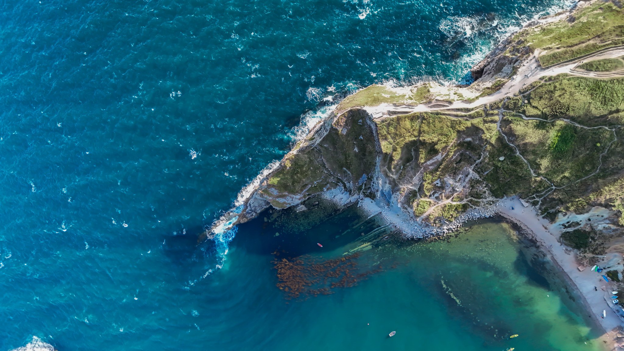 Aerial view of cliffs and blue sea