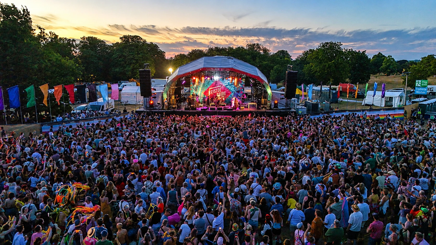 Aerial view of a large live event crowd facing a stage
