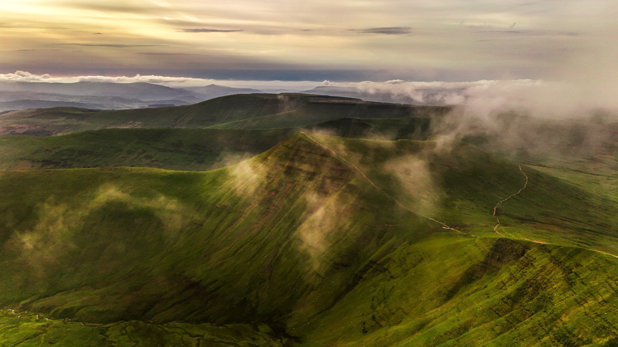 Aerial view of Pen y Fan surrounded by morning mist